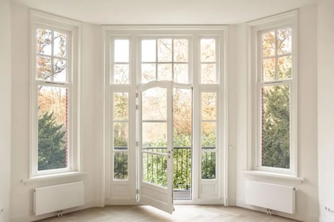 Bright white bay window unit installed in a finished living room